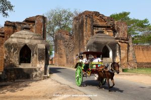 Tharabar Gate Horse Cart, Old Bagan - The gateway to Old Bagan is Tharabar Gate, the best preserved remains of the wall surrounding the former original palace site built in the 9th century. The gateway has two niches which house Burmese nat, who guard the gate and are treated with deep respect by the locals. Shown is Lady Golden Face.